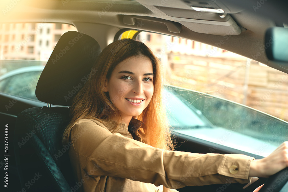 A beautiful smiling young woman enjoying driving on a beautiful sunny day A beautiful smiling young woman enjoying driving on a beautiful sunny day