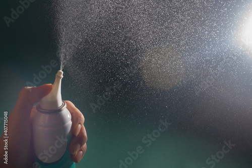 Spray the nasal spray with an aerosol. Small splashes of sea water. photo