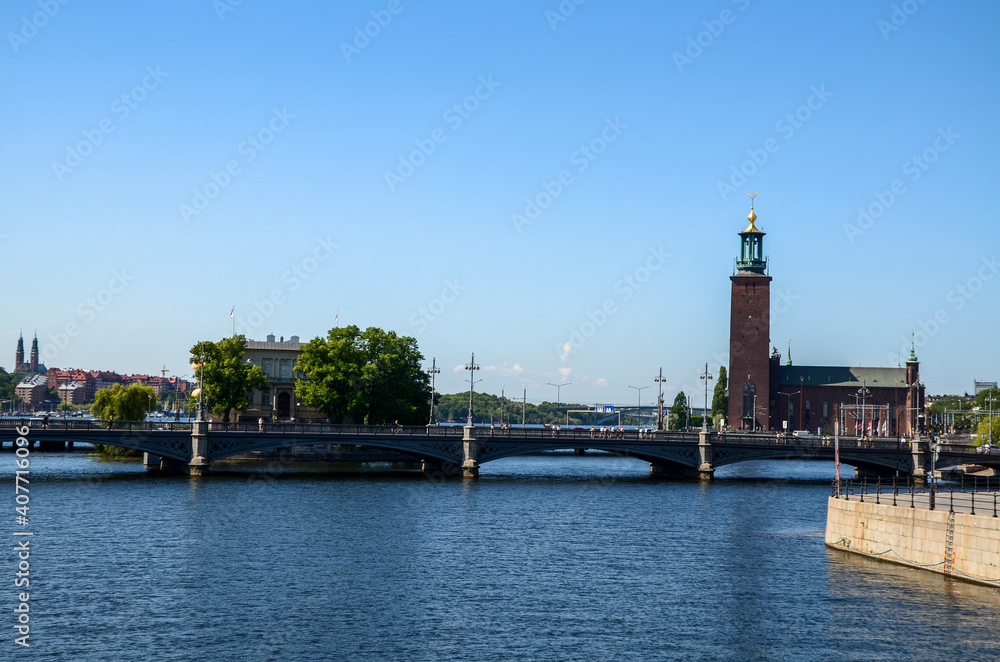 Clock tower of Stockholm City Hall and a Vasabron bridge over canal in the Old Town of Stockholm, Sweden