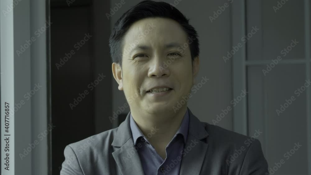 Portrait of Businessman smiling to camera at office. Portrait of Businessman smiling to camera at office.