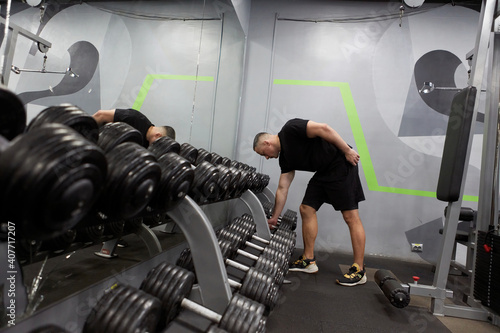 Man in the training gym  working hard after quarantine.