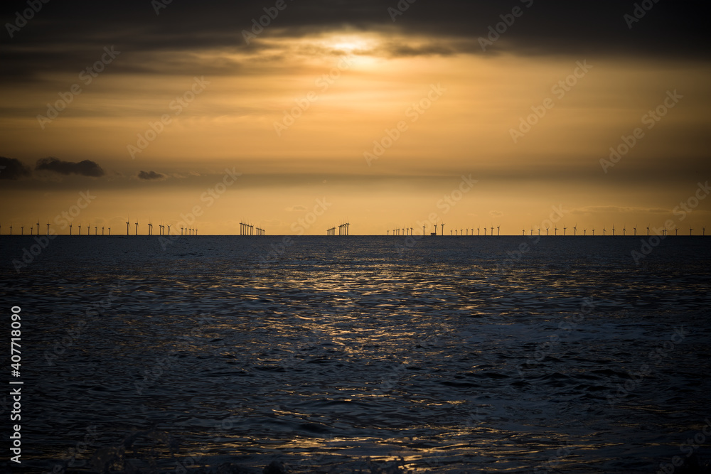 Offshore wind farm across the water at dusk
