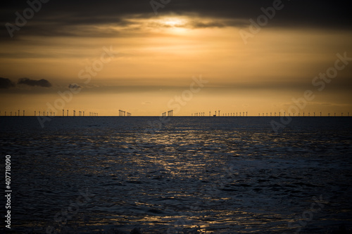 Offshore wind farm across the water at dusk 