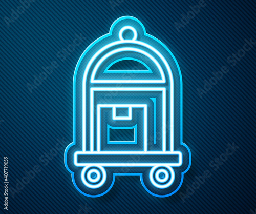 Glowing neon line Hotel luggage cart with suitcase icon isolated on blue background. Traveling baggage sign. Travel luggage icon. Vector.