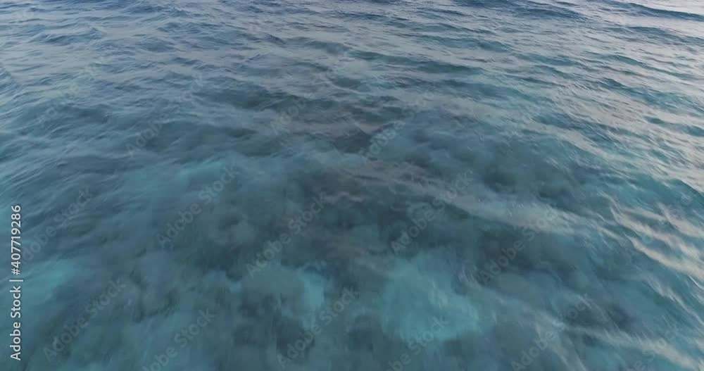 The drone flies over the sea in the Maldives, in sport mode, low to the sea and the waves in which the glare of the sun is reflected. The drone flies over the sea in the Maldives, in sport mode, low to the sea and the waves in which the glare of the sun is reflected.