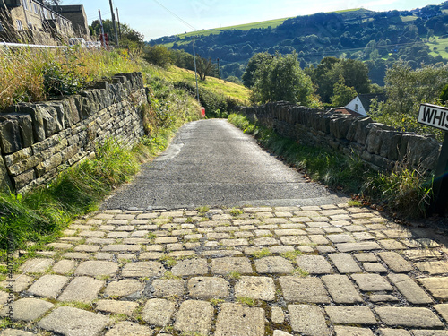 Whiskers Lane, with stone walls, fields and hills in the distance near, Shibden Valley, Halifax, UK