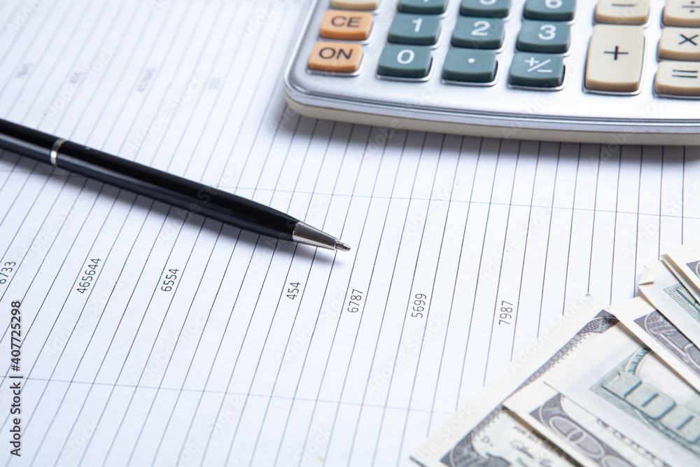 Close up calculator and financial report - accounting concept Close up calculator and financial report - accounting concept