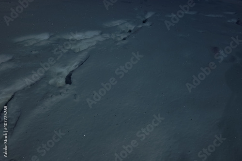 footprint in the snow at night 