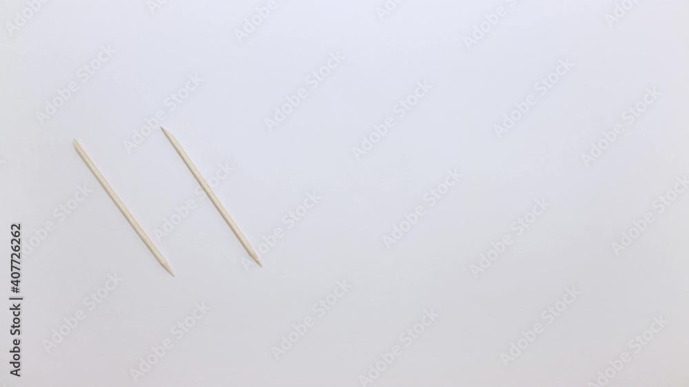 Close-up of a man's hand puts five orange nail sticks. Demonstration of tools for manicure. Items for work on a light surface. Professional hand care. Isolated video on a white background. Close-up of a man's hand puts five orange nail sticks. Demonstration of tools for manicure. Items for work on a light surface. Professional hand care. Isolated video on a white background.