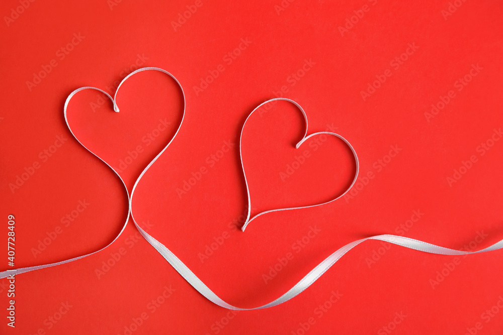 Hearts made of white ribbon on red background, flat lay. Valentine's day celebration Hearts made of white ribbon on red background, flat lay. Valentine's day celebration