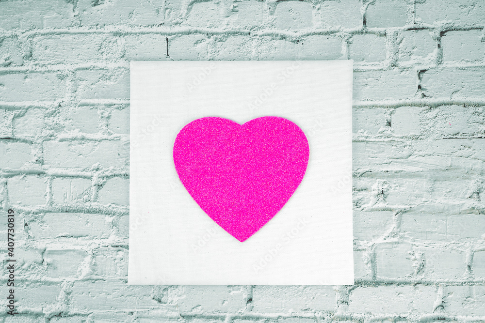 Rose glitter heart in the white pictures frame on the white bricks wall background. Love or Valentines concept. Rose glitter heart in the white pictures frame on the white bricks wall background. Love or Valentines concept.