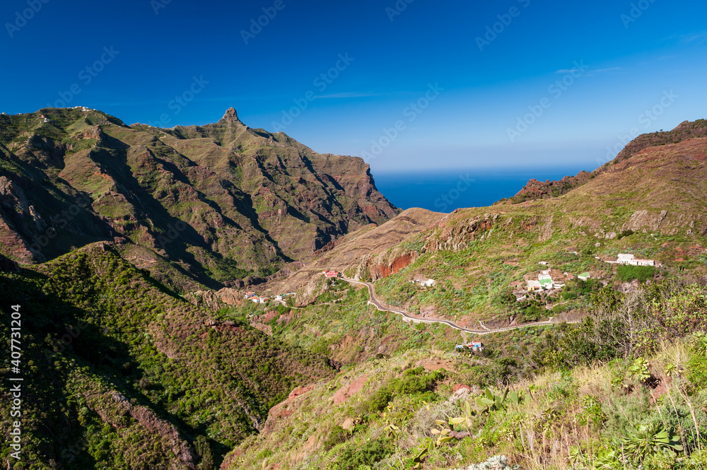 Houses bult in rock. Beautiful mountain landscape on tropical island Tenerife, Canary in Spain. Anaga mountains. Anaga mountain in Tenerife, Spain, Europe. Picturesque places Houses bult in rock. Beautiful mountain landscape on tropical island Tenerife, Canary in Spain. Anaga mountains. Anaga mountain in Tenerife, Spain, Europe. Picturesque places