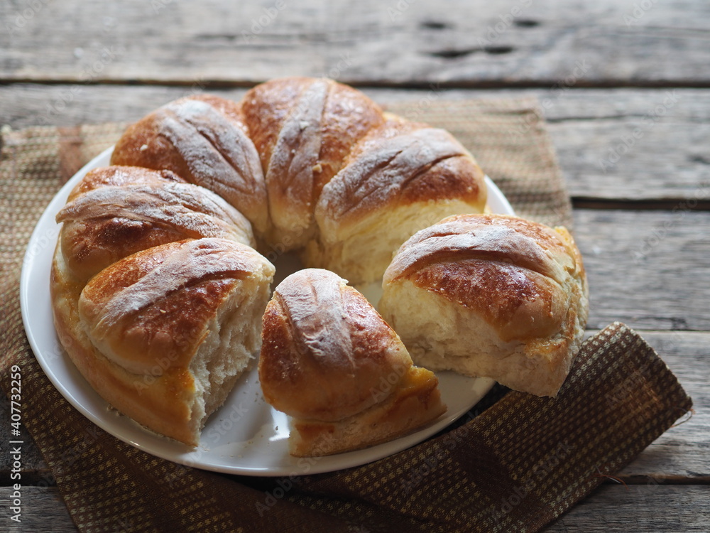 Homemade buns on a wooden background with a napkin.Festive and casual, healthy and natural food. Homemade buns on a wooden background with a napkin.Festive and casual, healthy and natural food.