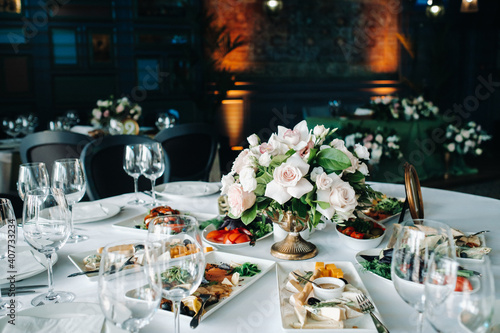 wedding table decoration with flowers on the table in the castle, table decor for dinner by candlelight.Dinner with candles photo