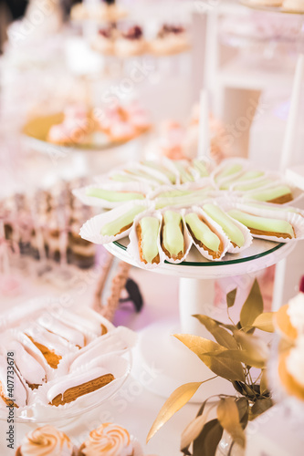 Delicious and tasty dessert table with cupcakes and shots at reception closeup