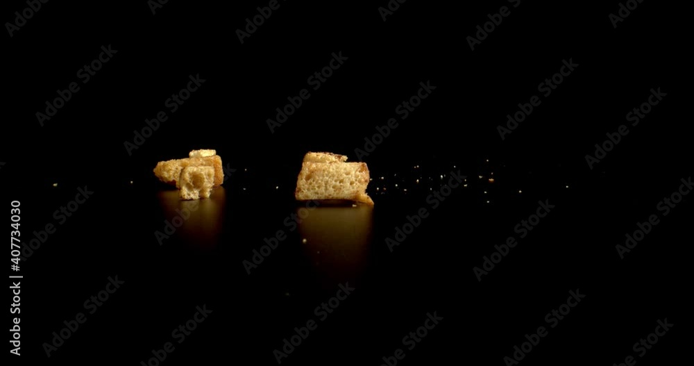 Salty oiled Bread crumbs falling on black background. Crackers Food Crisps Snacks close up. High quality. Salty oiled Bread crumbs falling on black background. Crackers Food Crisps Snacks close up. High quality.