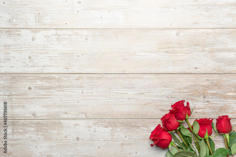 Red roses in bouquets, wooden surface. Layout for postcards, invitations for Valentine's Day 14 february, Engagement, wedding anniversary, Birthday, romantic evening  preparation