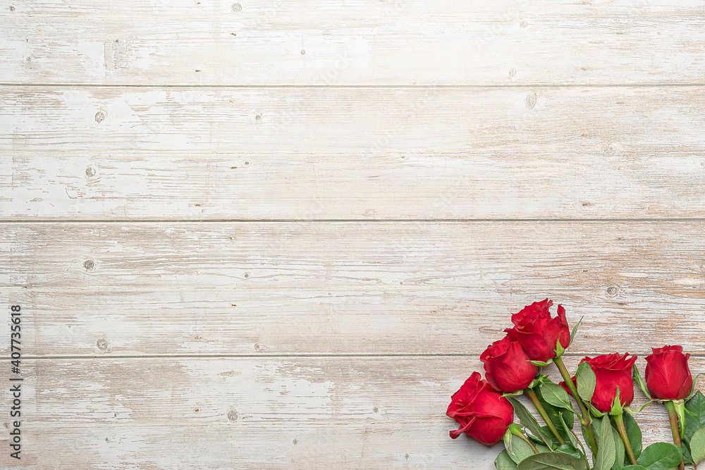 Red roses in bouquets, wooden surface. Layout for postcards, invitations for Valentine's Day 14 february, Engagement, wedding anniversary, Birthday, romantic evening preparation Red roses in bouquets, wooden surface. Layout for postcards, invitations for Valentine's Day 14 february, Engagement, wedding anniversary, Birthday, romantic evening preparation