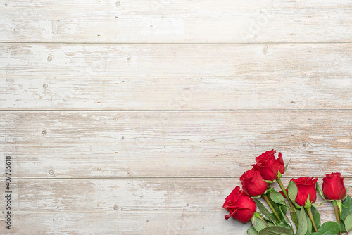 Red roses in bouquets, wooden surface. Layout for postcards, invitations for Valentine's Day 14 february, Engagement, wedding anniversary, Birthday, romantic evening  preparation