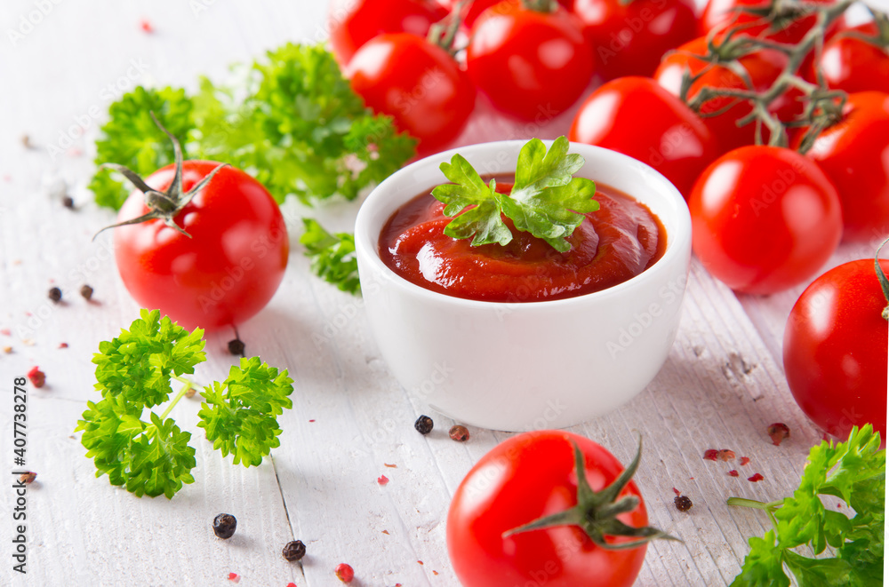 bowl of ketchup or tomato sauce and fresh tomatoes on wood table bowl of ketchup or tomato sauce and fresh tomatoes on wood table