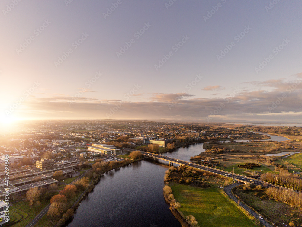 Bridge over river Corrib, Galway city, Ireland. Sunset time. Clean sky. Aerial view.