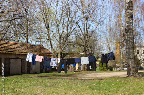 Laundery drying outside. Clothes hanging on the rope in the garden. photo