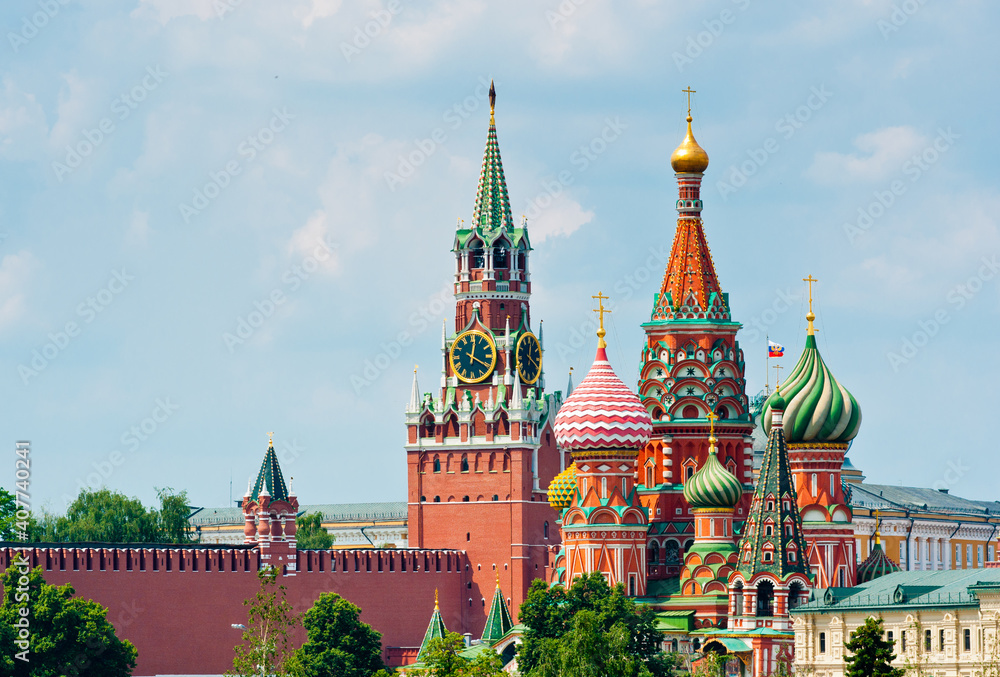 Spasskaya Tower of Moscow Kremlin and the Cathedral of Vasily the Blessed (Saint Basil's Cathedral) on Red Square. Summer sunny day. Moscow. Russia Spasskaya Tower of Moscow Kremlin and the Cathedral of Vasily the Blessed (Saint Basil's Cathedral) on Red Square. Summer sunny day. Moscow. Russia