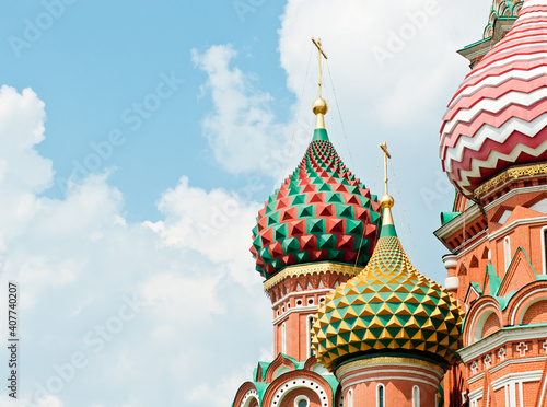 Domes of the Cathedral of Vasily the Blessed (Saint Basil's Cathedral)  against blue sky with white clouds. Close-up. Red square. Moscow. Russia