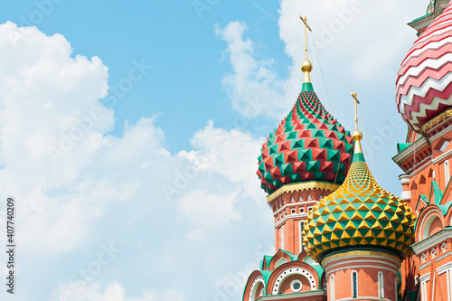 Domes of the Cathedral of Vasily the Blessed (Saint Basil's Cathedral)  against blue sky with white clouds. Close-up. Red square. Moscow. Russia