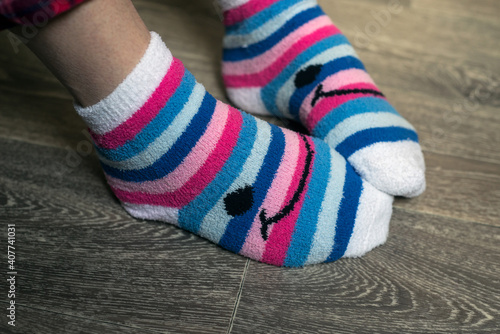 Closeup of pink stripped socks on feet of woman at home