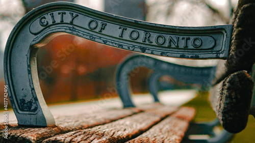 Photography Selective focus shot of the City of Toronto sign on a wood bench in Ontario, C