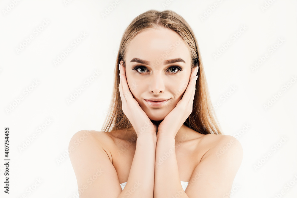 Happy beautiful girl holding her cheeks with a laugh looking at the camera. Expressive facial expressions. Cosmetology, beauty and Spa. Happy beautiful girl holding her cheeks with a laugh looking at the camera. Expressive facial expressions. Cosmetology, beauty and Spa.
