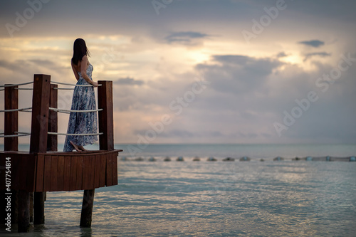 Person watching the sunset on a pier © Pawel