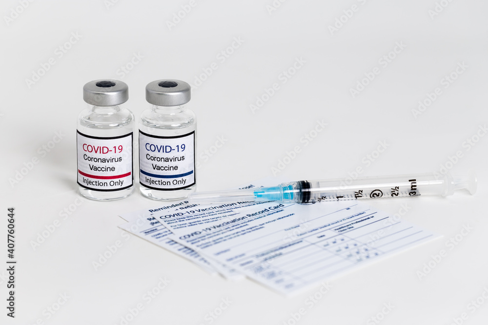 Covid-19 vaccine and syringe on white background.