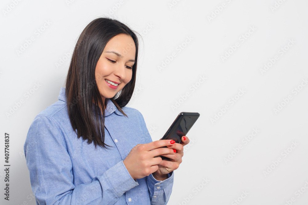 Young woman using a smartphone on white Young woman using a smartphone on white