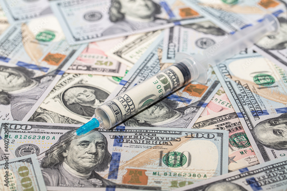 Syringe with 100 dollar banknote inside on dollar banknotes Syringe with 100 dollar banknote inside on dollar banknotes