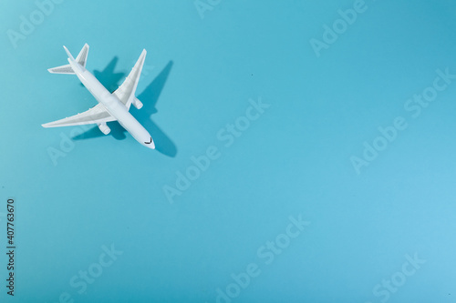 toy airplane on blue background top view with space for text