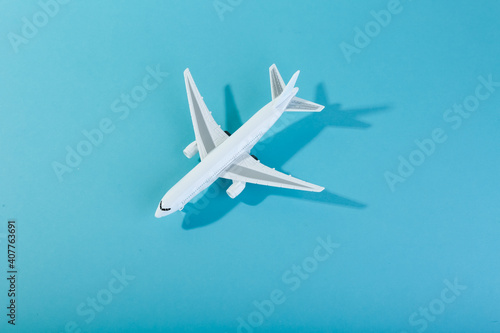 toy airplane on blue background top view with space for text