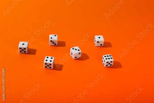 dice on orange background top view with copy space. 