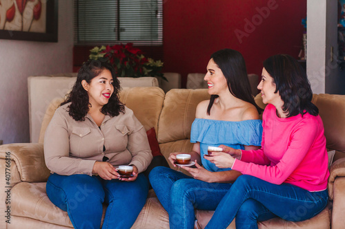 Latin women friends hanging out and drinking coffee in home in Mexico city © Marcos