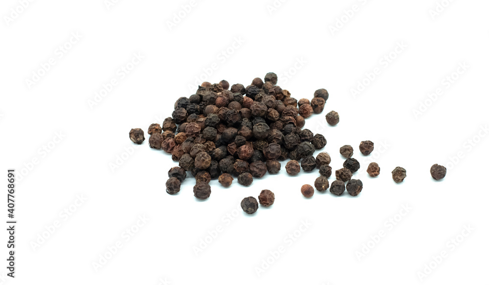 Black peppercorns on a white background. Close-up. The most famous classic spice. Black peppercorns on a white background. Close-up. The most famous classic spice.