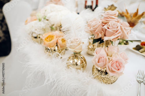 wedding table decoration with flowers on the table in the castle, table decor for dinner by candlelight.Dinner with candles photo