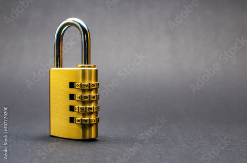 Close-up combination lock with chrome numerals on black background. photo