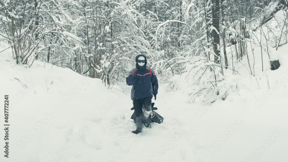 Rescue robot in a plastic mask, black glasses drags stretcher with an injured person through snow. Concept of parody, cyberpunk and post apocalyptic Rescue robot in a plastic mask, black glasses drags stretcher with an injured person through snow. Concept of parody, cyberpunk and post apocalyptic