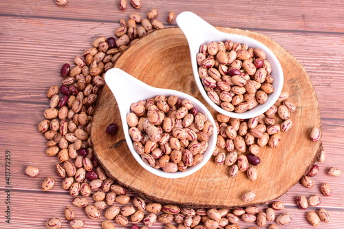 Natural bean grains Phaseolus vulgaris on dark grain wood background