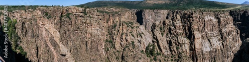 Panorama shot of edge of rocky walls in black canyon of gunnison at sunny day in america