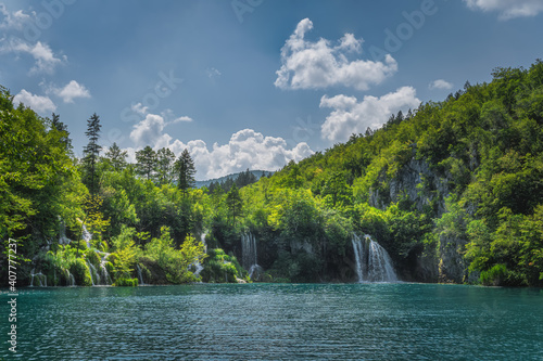 Many waterfalls with water coming down from lichens and plants to turquoise coloured lake. Plitvice Lakes National Park UNESCO World Heritage, Croatia