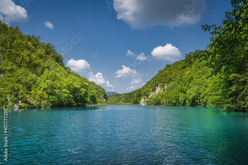 Clean, turquoise coloured, lake surrounded by hills and green lush forest, Plitvice Lakes National Park UNESCO World Heritage in Croatia © Dawid