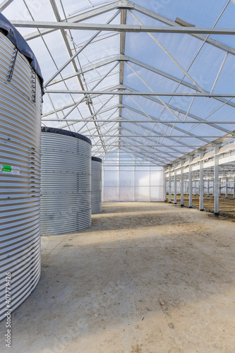 Three huge water storage tank in the greenhouse