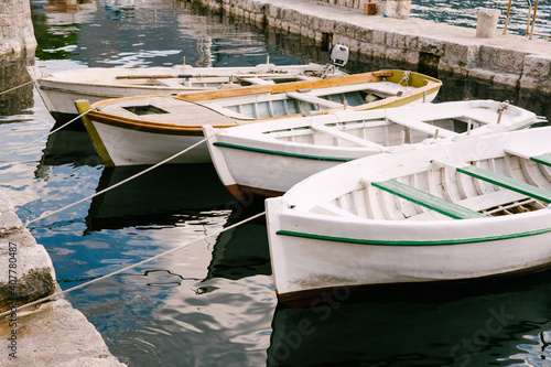 Close-up of white boats moored at the pier. © Nadtochiy